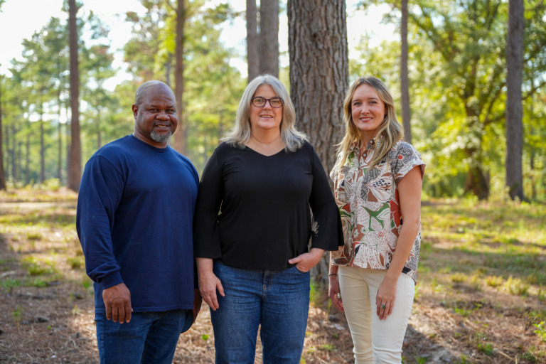 Crooked Oaks staff standing within forest