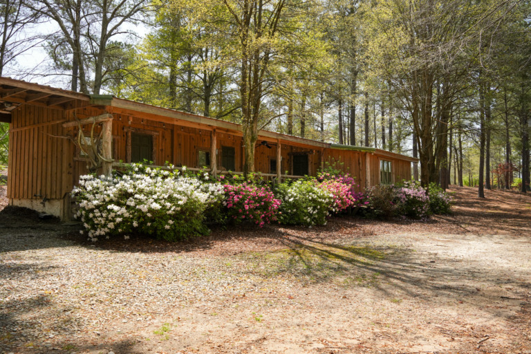 The Crooked Oaks cabin exterior with colorful blooms.