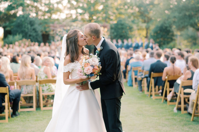 bride and groom kiss after ceremony