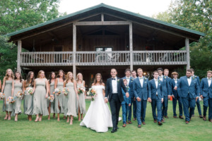 wedding party gather in front of lodge