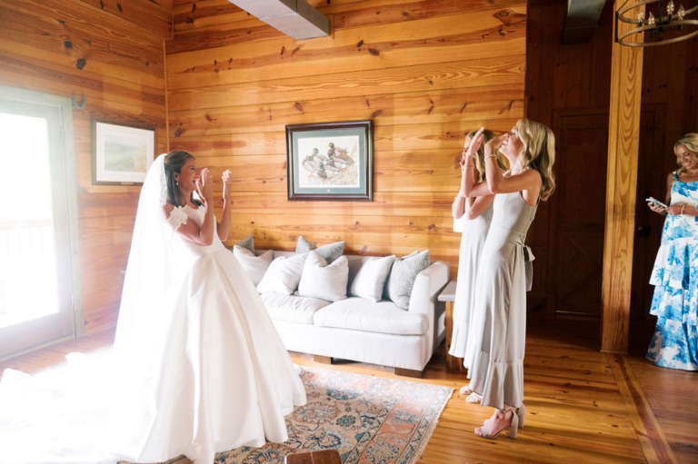 bride and attendees inside lodge sitting room laughing