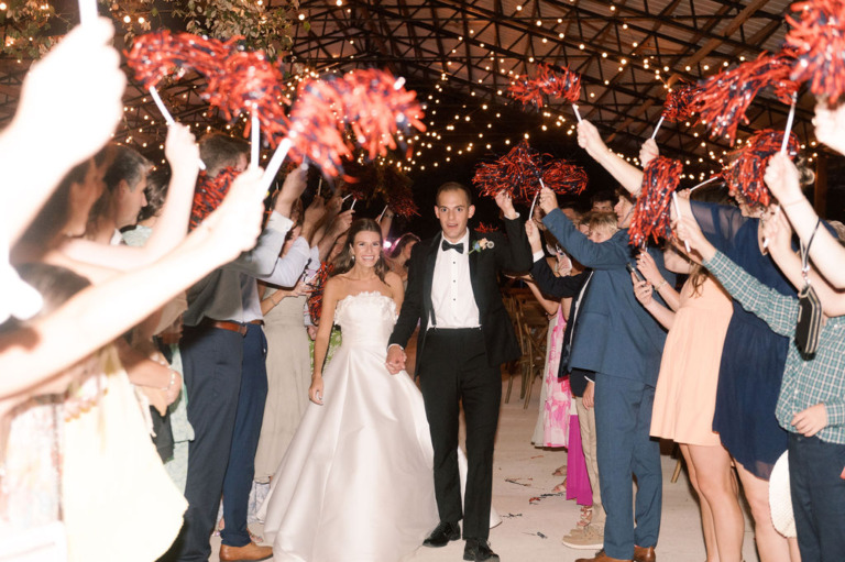 bride and groom celebrated as they leave wedding reception
